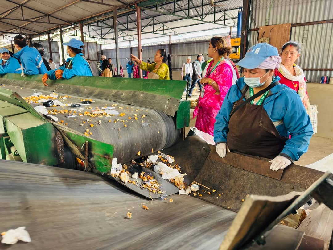 Workers sorting waste at a recycling plant in Butwal, Nepal, highlighting community recycling efforts.