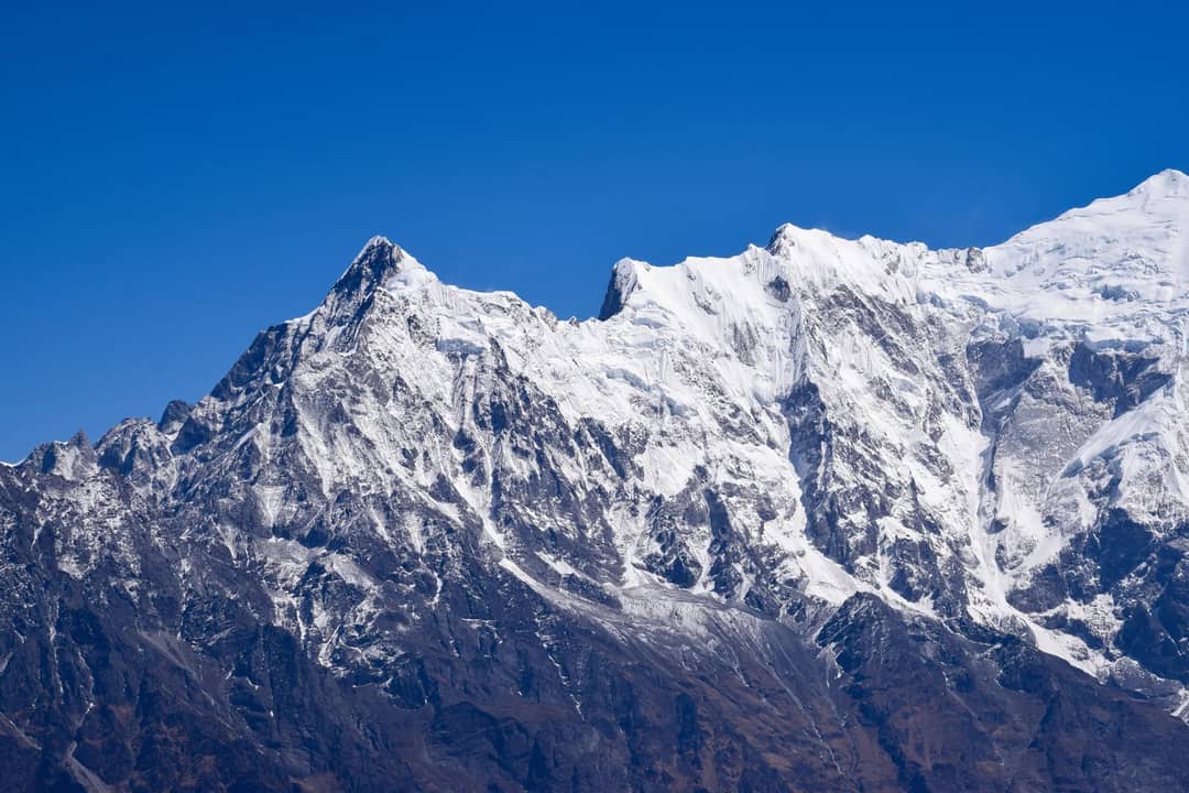 A snow-covered Himalayan peak against a clear sky