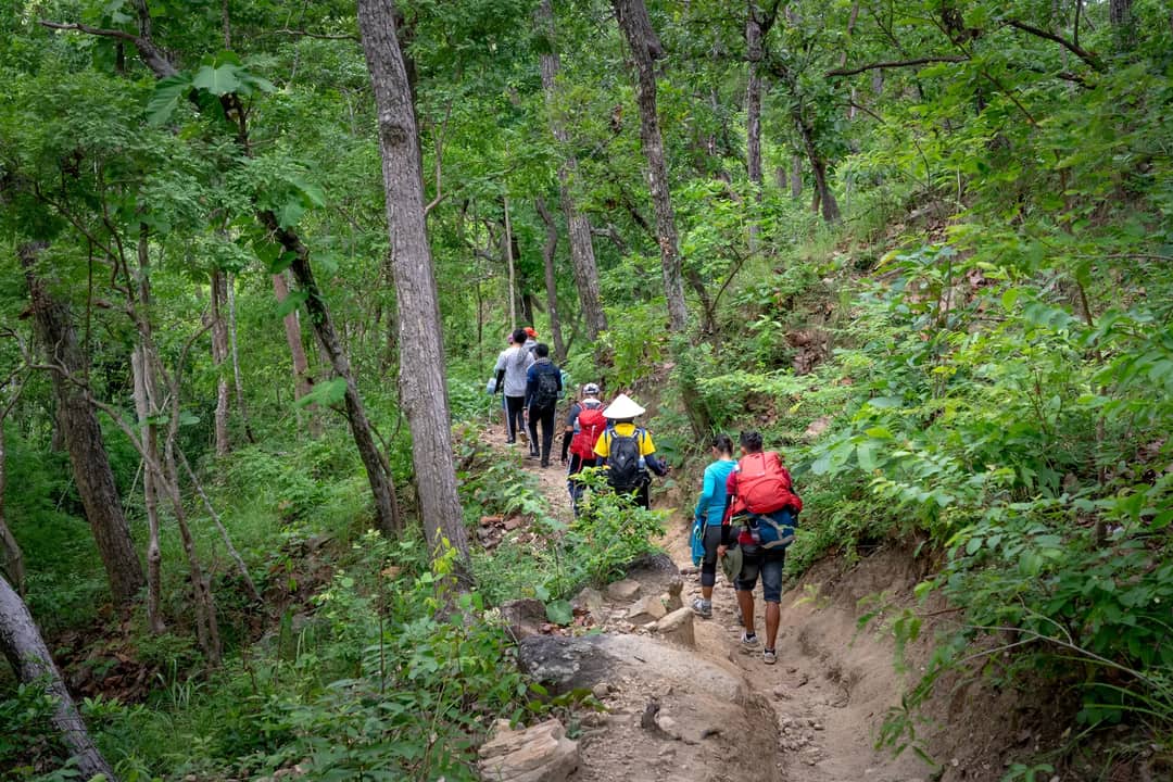 Trekkers walking a mountain trail in Nepal