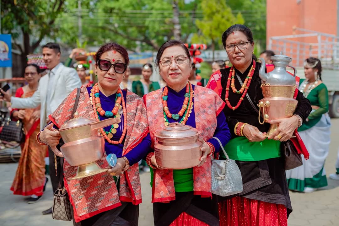 Women in traditional attire participate in a cultural festival in Butwal, Nepal, showcasing heritage vessels.
