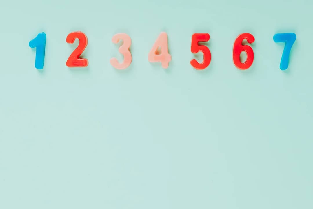 Bright plastic numbers on a blue background with ample copy space, ideal for educational themes.