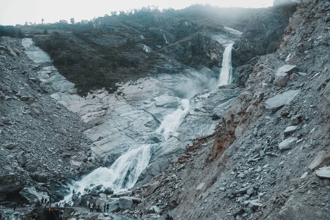 A breathtaking waterfall cascading through rocky terrain in Gandaki Province, Nepal.