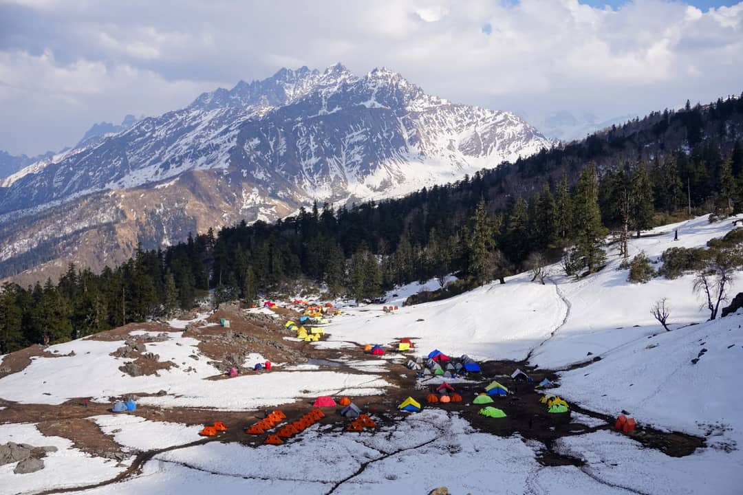 Explore the snowy mountains and colorful tents in Salud Dugra, Uttarakhand.