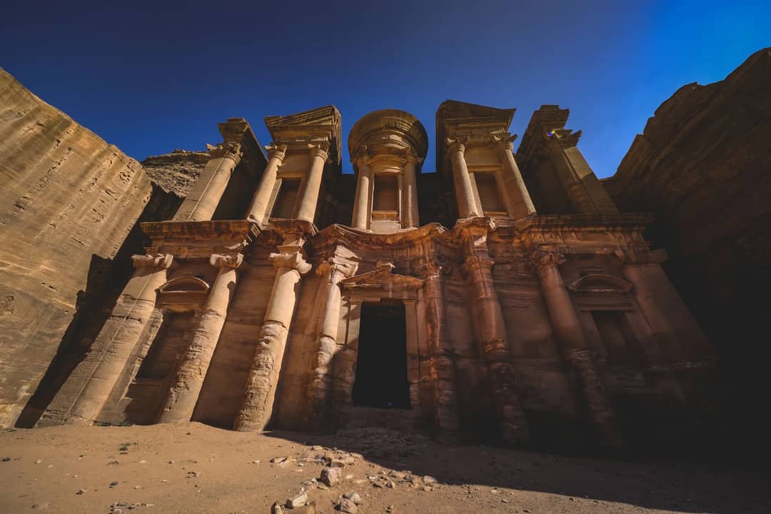 Explore the stunning facade of Ad Deir, an ancient monument carved into sandstone in Petra.