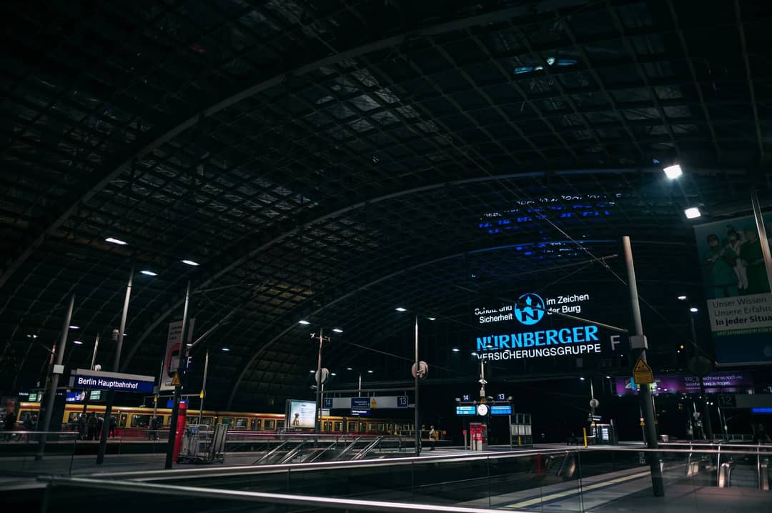 Illuminated Berlin Hauptbahnhof station at night showcasing modern architecture and transport hub.