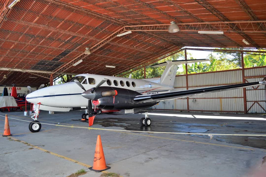 Private airplane parked in a spacious hangar in Ilopango, San Salvador.