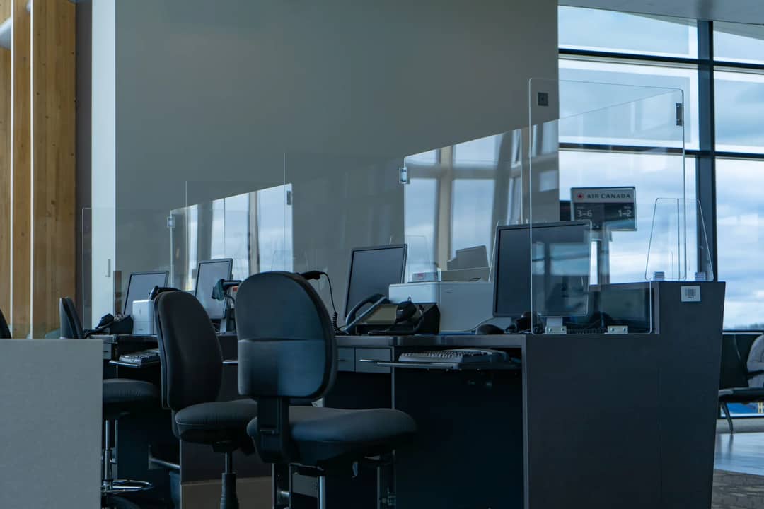 Empty desks and screens in an airport terminal before the day starts