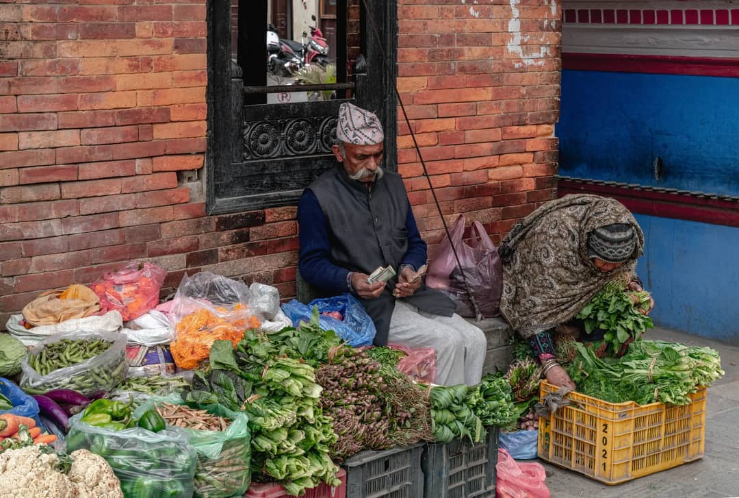 A vibrant market scene with vendors selling fresh produce in Kathmandu, Nepal.