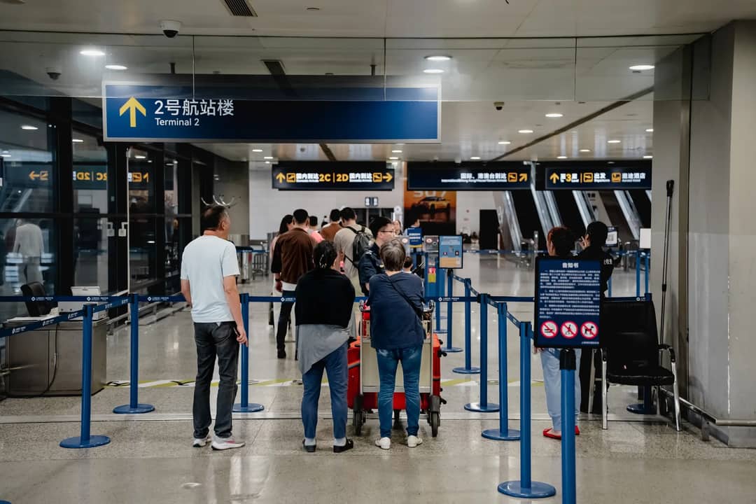 Passengers queue at Terminal 2 in Shanghai Airport, China.