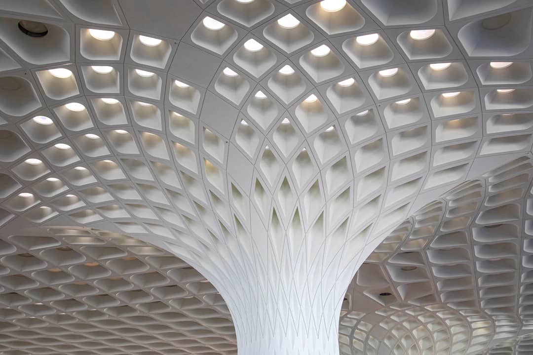 Intricate modern ceiling design at Mumbai Airport showcasing architectural excellence.