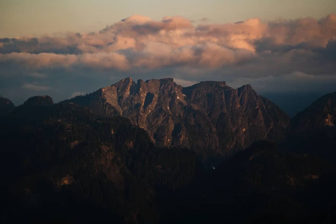 Discover the breathtaking beauty of a majestic mountain range under a stunning sunset sky in this amazing snapshot.