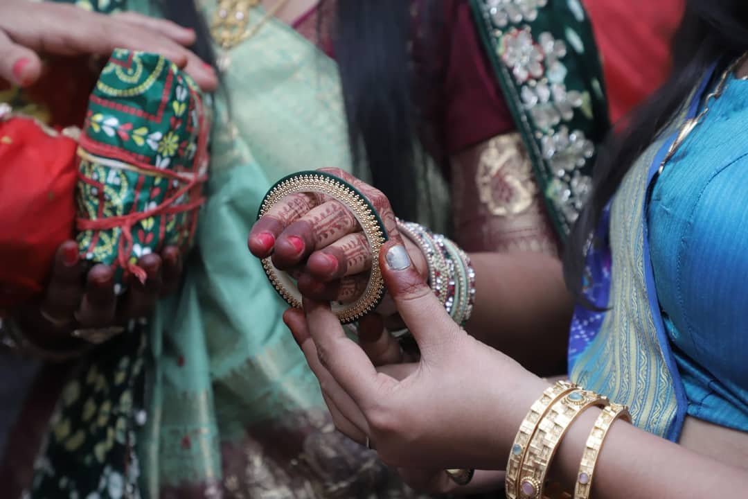 Women exchanging gifts during a vibrant traditional ceremony