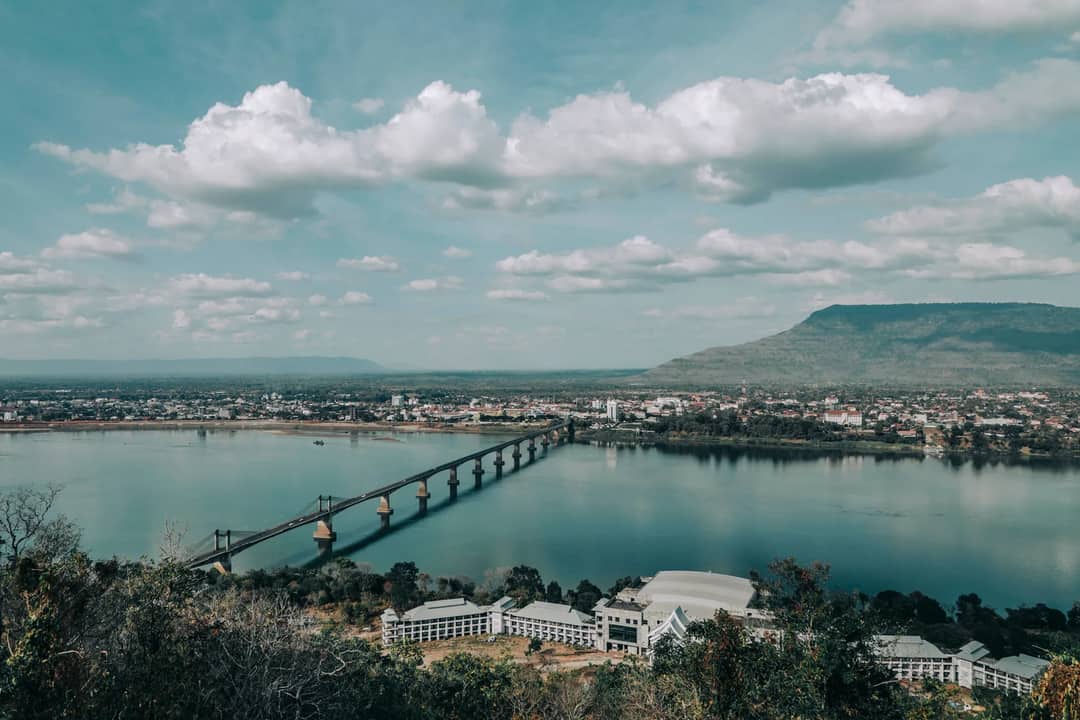 A river and a long bridge beside a riverside town