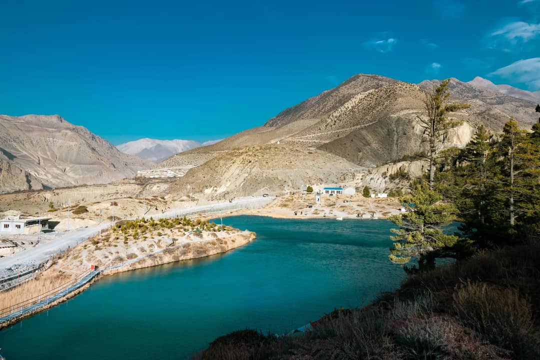 Pristine turquoise lake surrounded by mountains in Gandaki Province, Nepal.