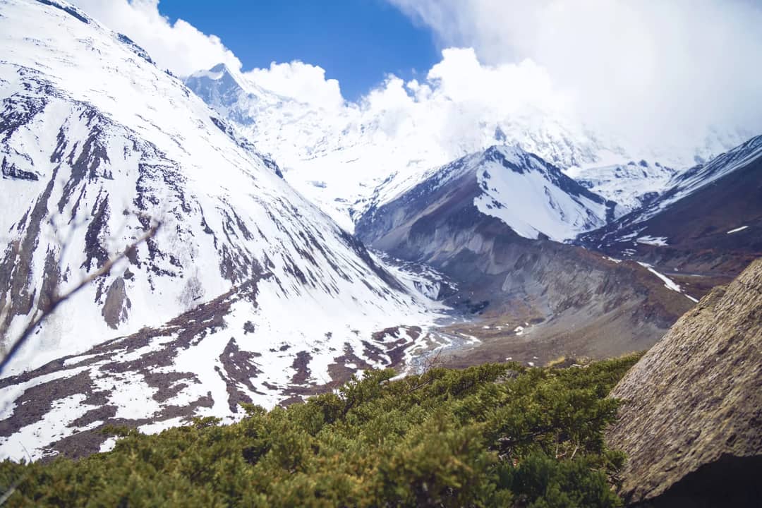 Scenic view of snow-covered mountains and valley in Manang, Nepal during winter.