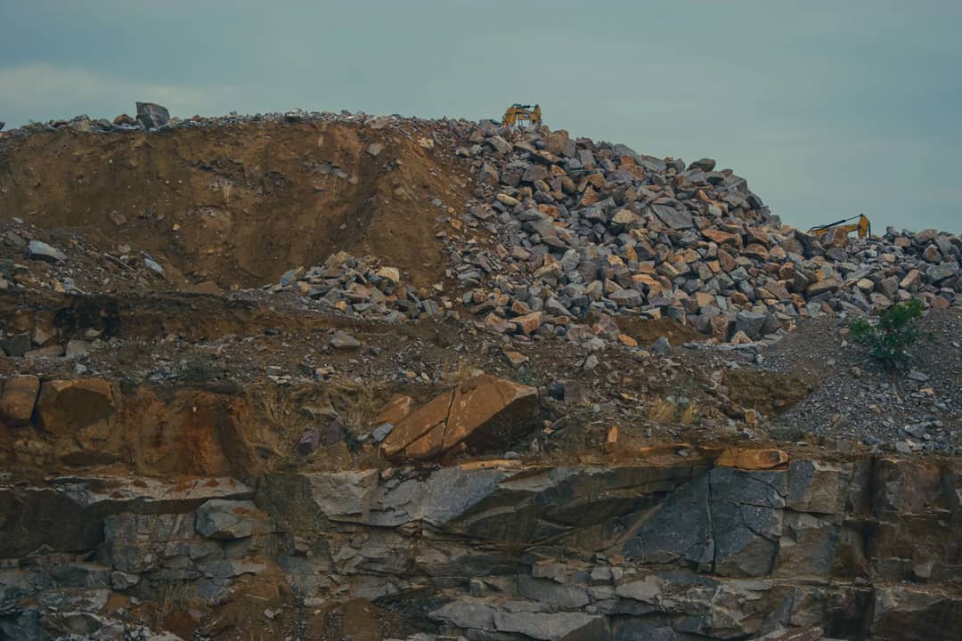 An expansive rocky landscape showcasing a large heap of stones and earth.