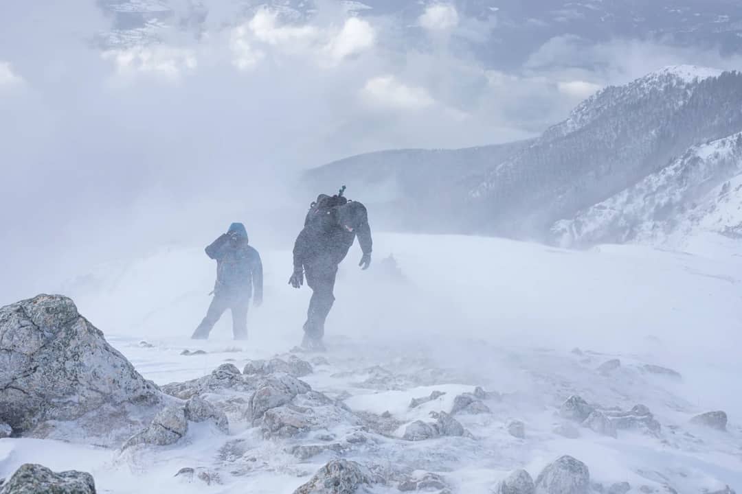 Adventurous hikers braving harsh winter conditions in the mountains of Bosnia.