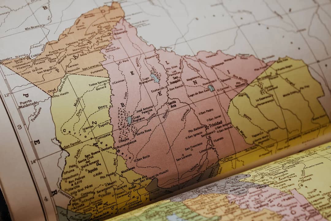 Detailed vintage map showing geographic regions in an old atlas book, highlighting Mérida, Venezuela.