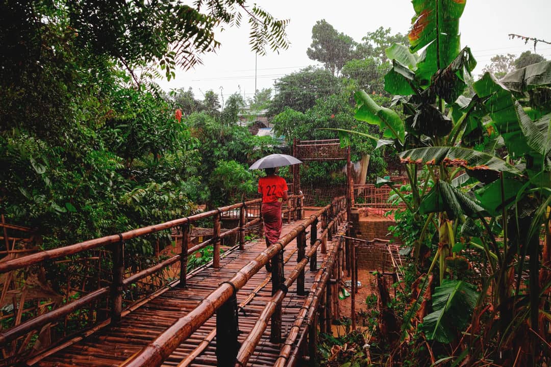 Heavy monsoon rain over green hills — days of sustained rain that no garment stays dry through