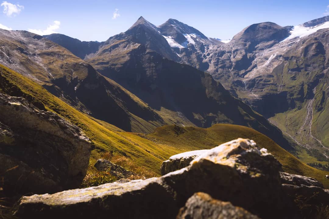 Breathtaking view of the alpine mountain range with rugged peaks and rocky terrain in daylight.