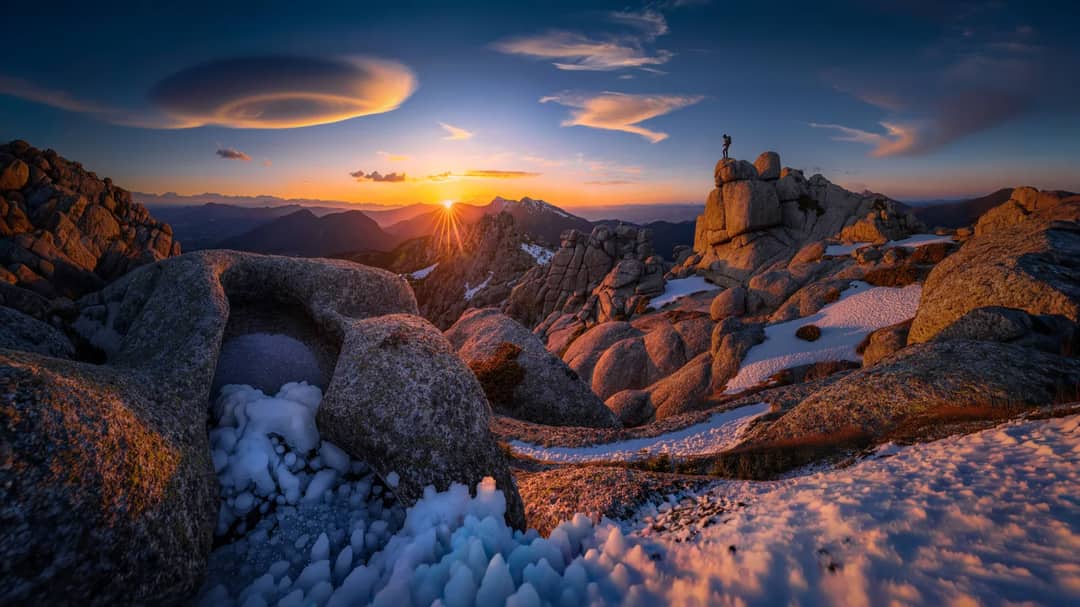 Wind-driven cloud streaming off a high summit, the visible signature of the jet stream striking the range