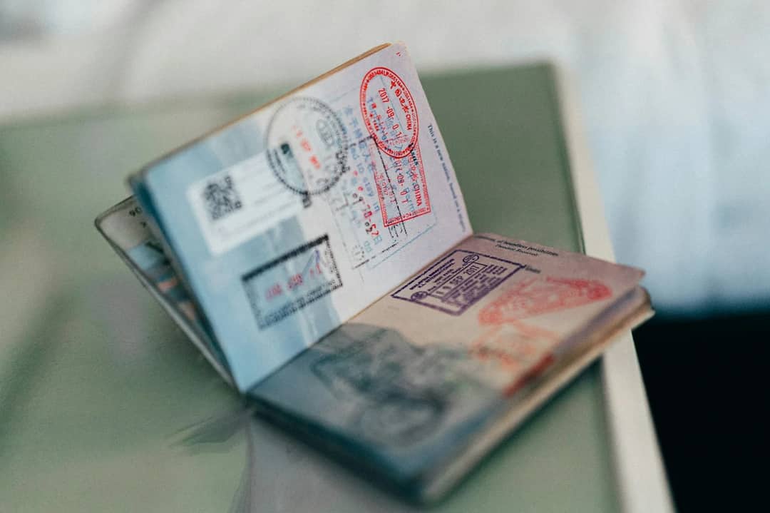 An open passport with multiple colorful ink stamps on the pages