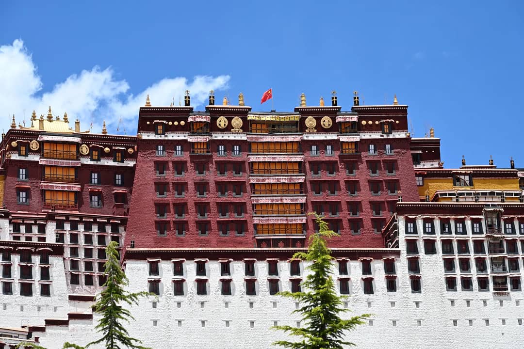 Potala Palace in Lhasa, Tibet, a historical and architectural marvel under a clear blue sky.