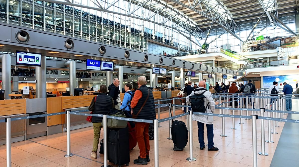 Travellers queueing at check-in counters at Hamburg Airport