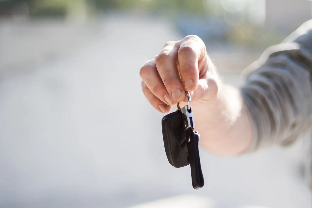 A hand passing over a set of car keys