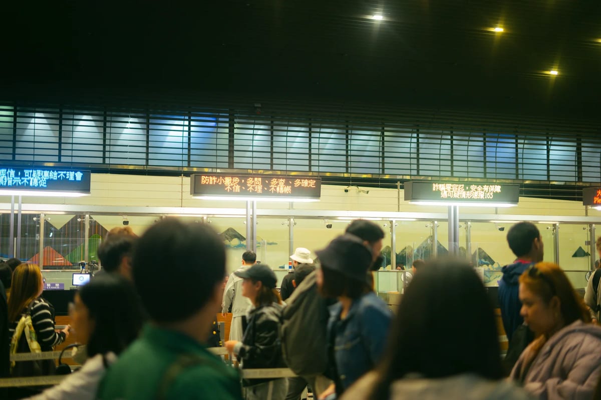 Travellers queueing in a crowded airport check-in hall