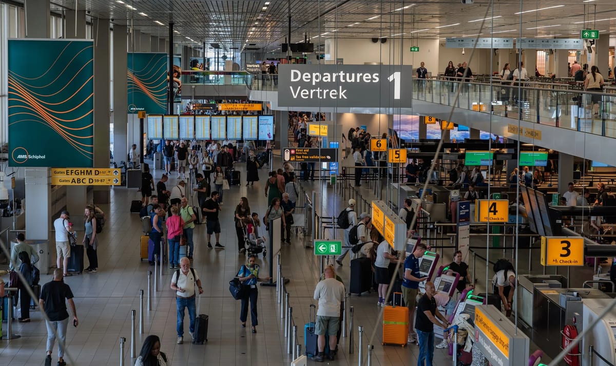 Crowds of travellers in the departure area of Amsterdam Schiphol Airport