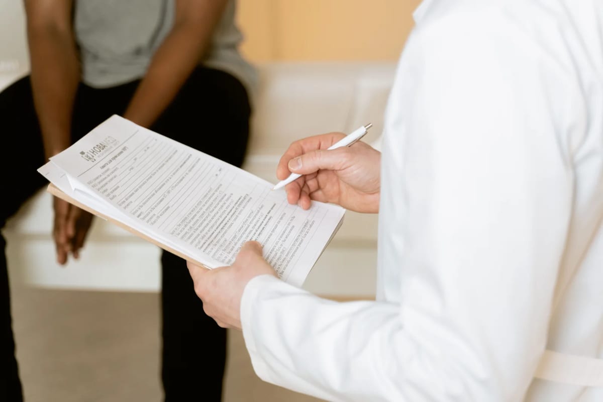 Healthcare professional reviewing a medical form with a patient