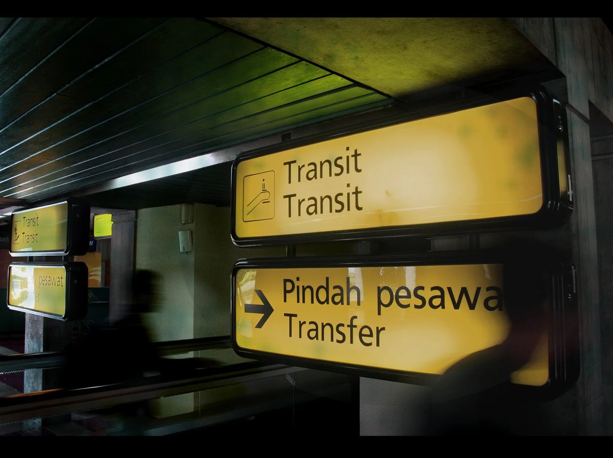 Illuminated transit and transfer signs in an airport terminal