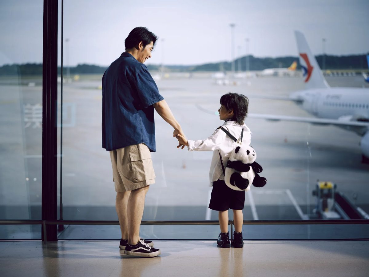 Father and child at an airport window