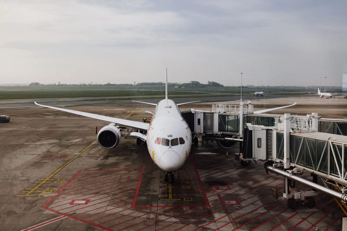 Jet airplane at a terminal gate on a cloudy day