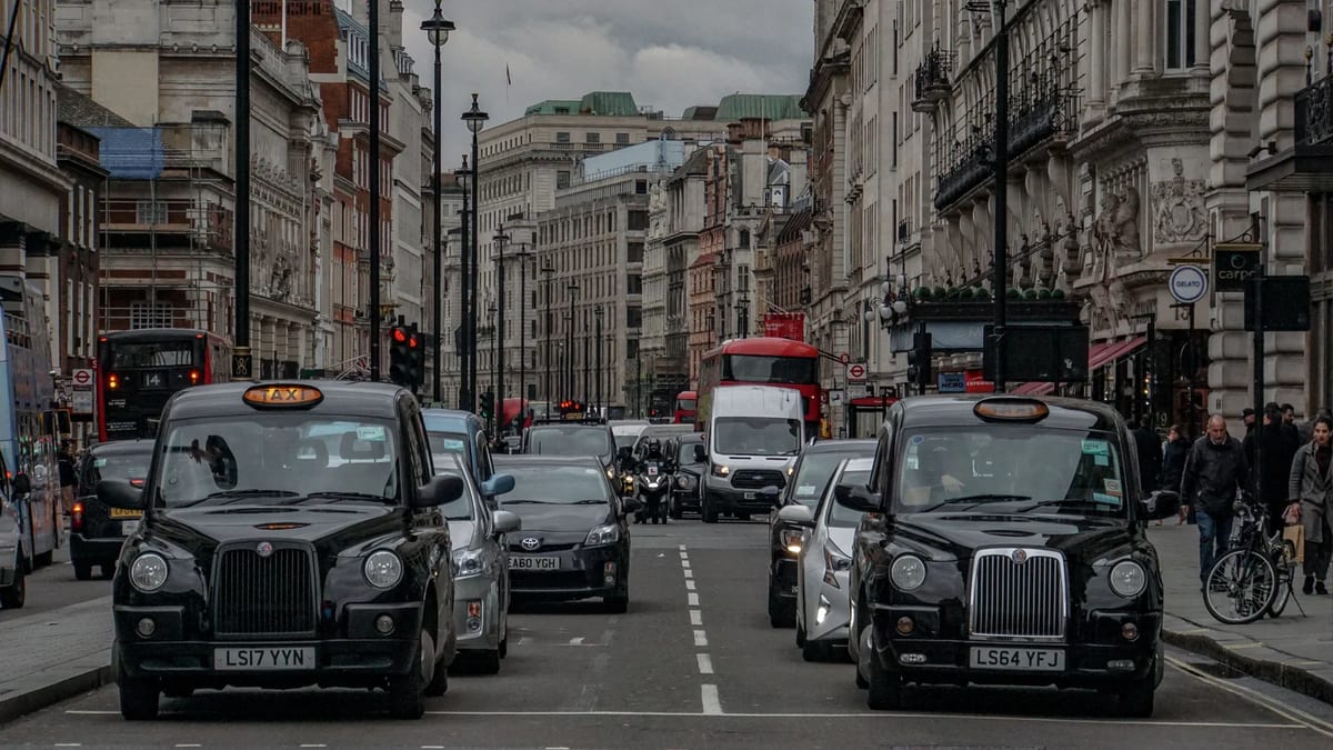 Black cabs and traffic on a busy central London street