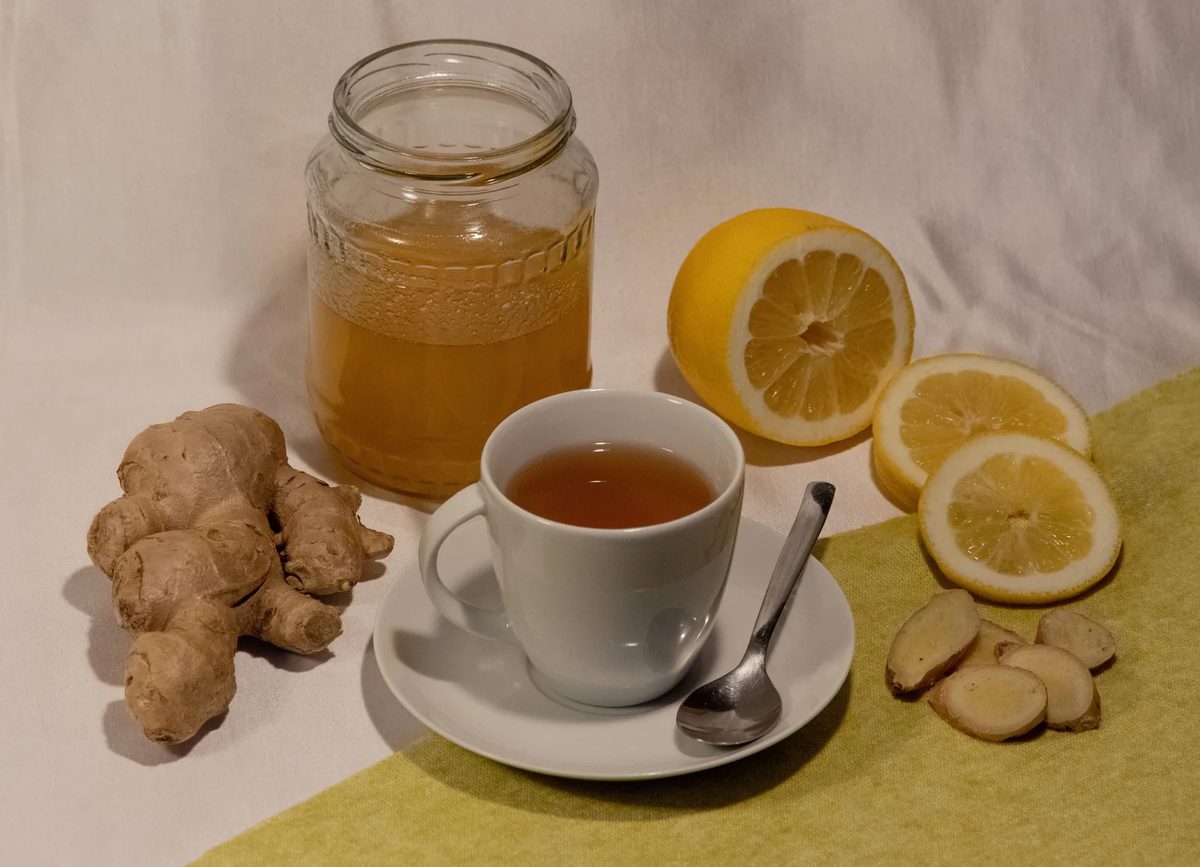 A cup of ginger and lemon tea with honey