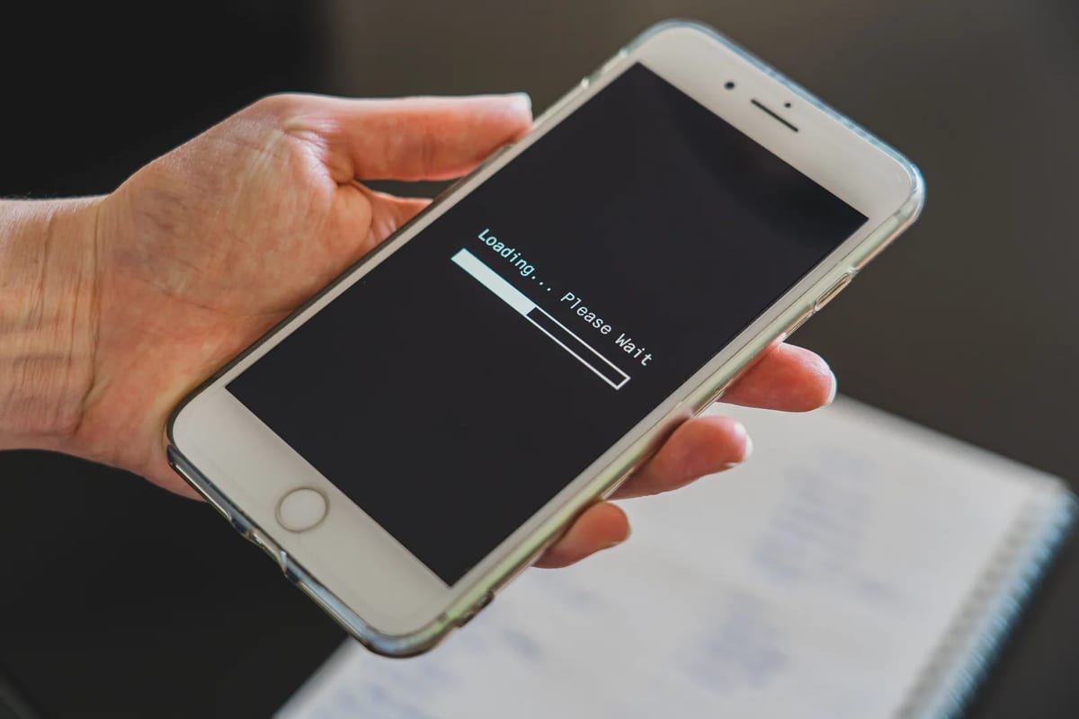 Close-up of a hand holding a smartphone with a loading screen