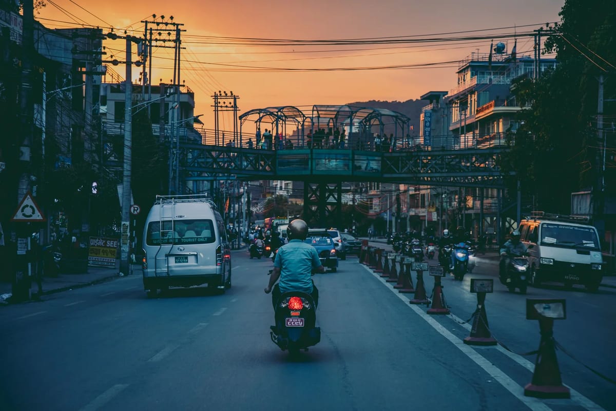 Evening street scene in Pokhara with traffic and shops