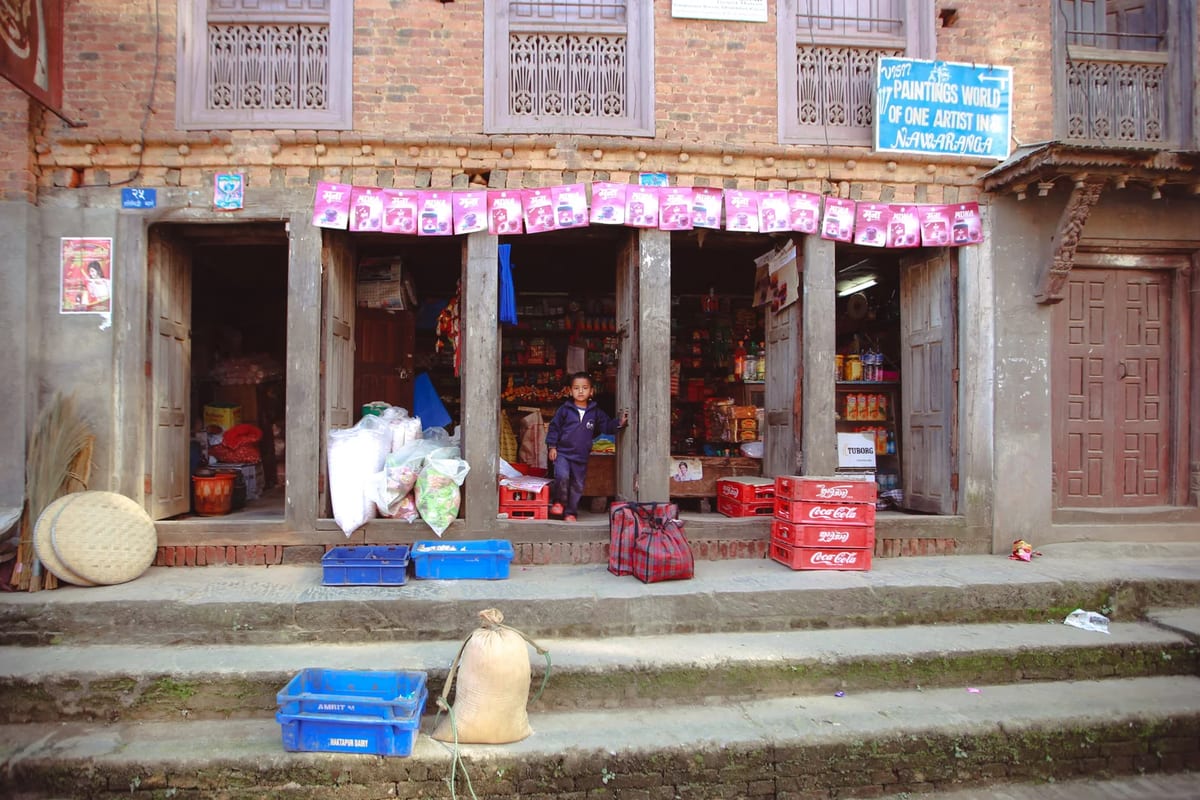 Child at the entrance of a traditional market in Kathmandu