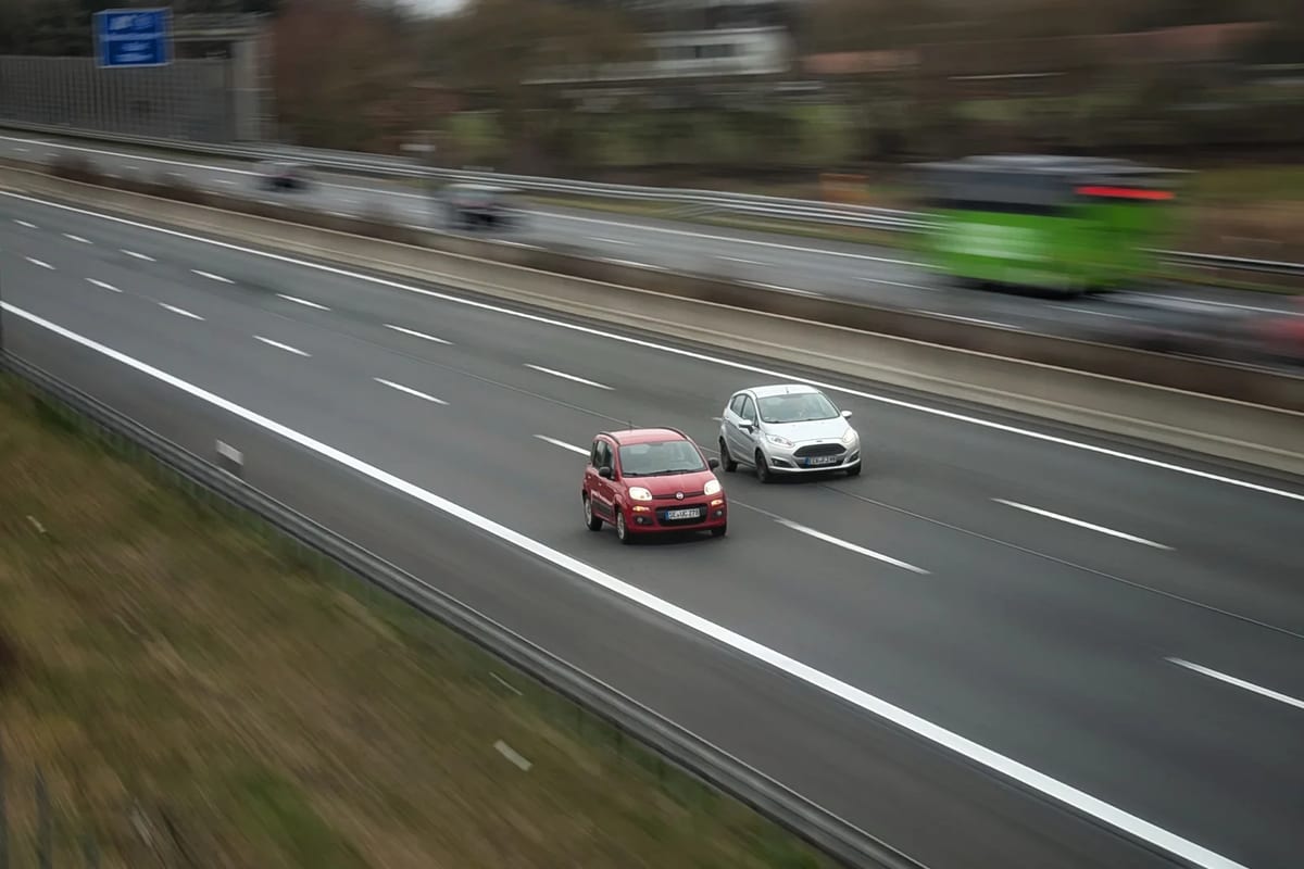Two cars on a European motorway seen from above