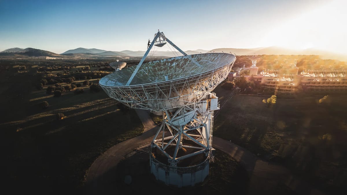 Large satellite dish in a rural landscape at sunrise