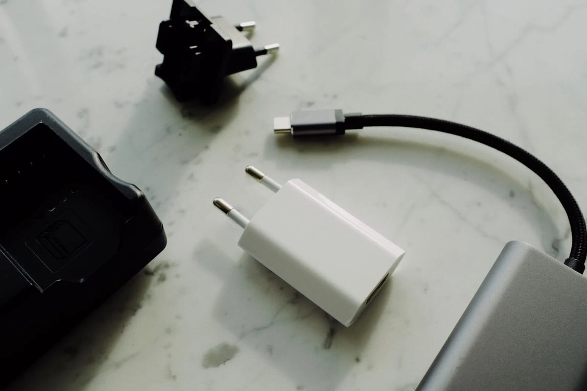 A set of charging adapters, cables and a small external battery pack