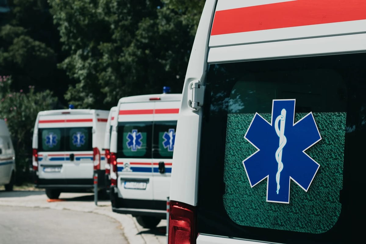 Three ambulances parked outdoors