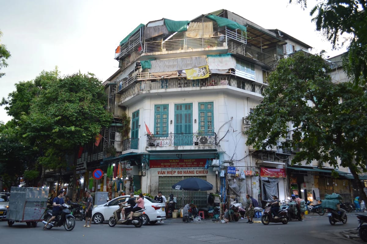 Street life in Hanoi's Old Quarter with motorbikes and shops