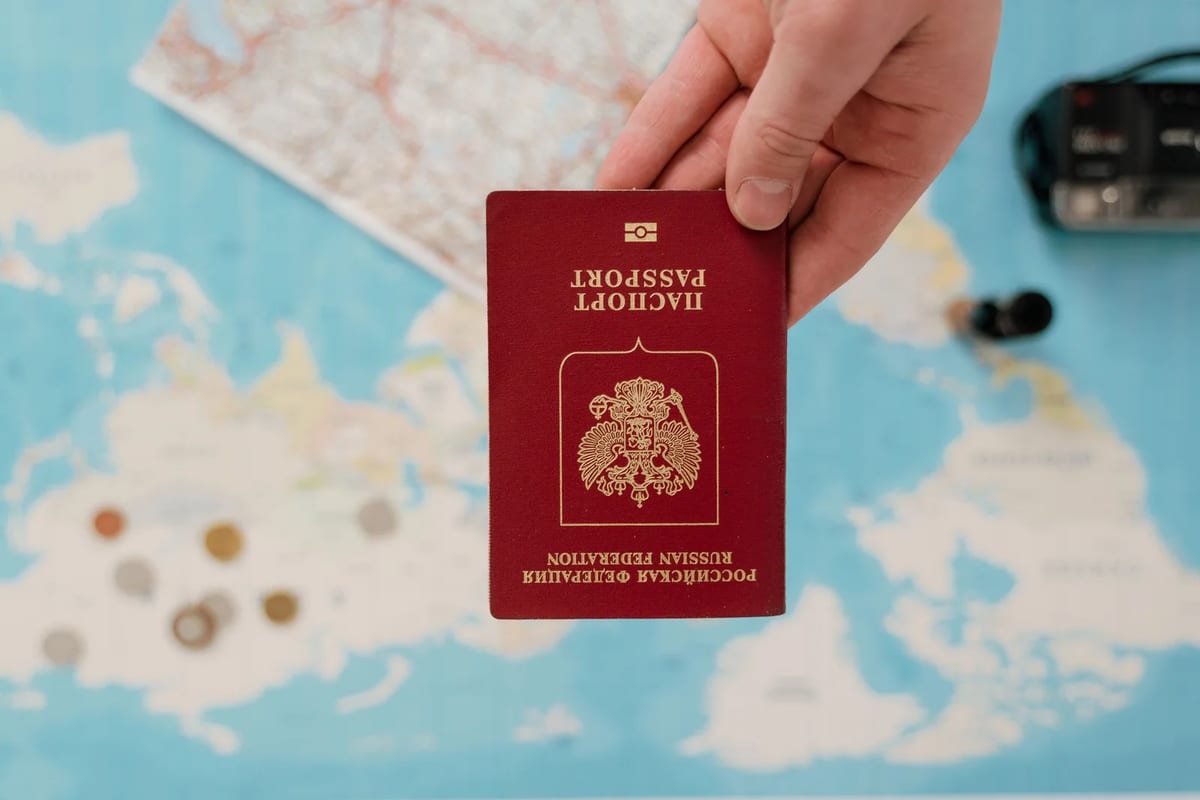 Hand holding a passport over a map