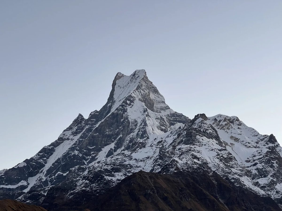 The snow-capped peak of Machapuchare against a clear blue sky