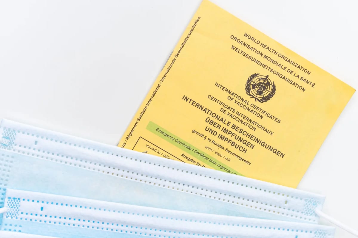 A passport and vaccination card on a table