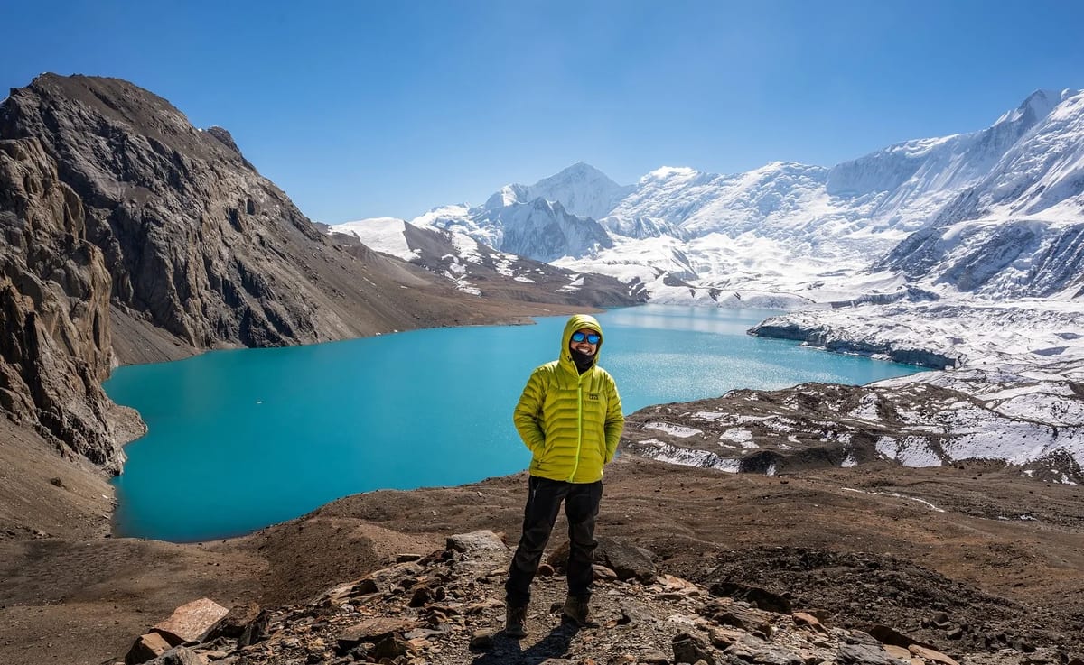 Turquoise Tilicho Lake below snow peaks