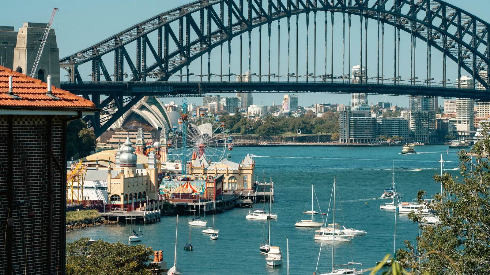 Sydney Harbour Bridge with Luna Park and sailboats